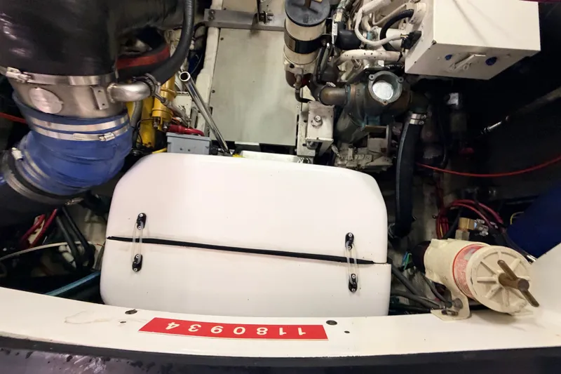 Slide: The Image of Engine compartment of a 2003 Luhrs 36 Open boat, showcasing mechanical components and wiring. - 26