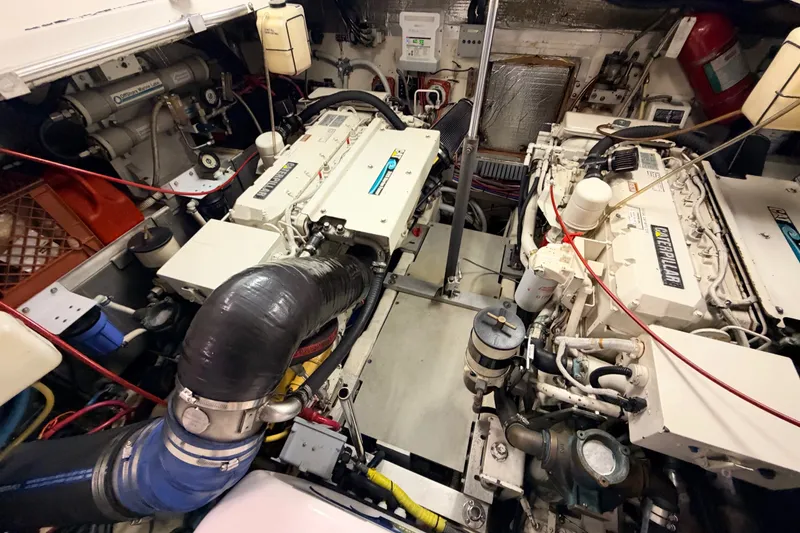 Slide: The Image of Engine room of a 2003 Luhrs 36 Open boat, featuring Caterpillar engines and mechanical components. - 23