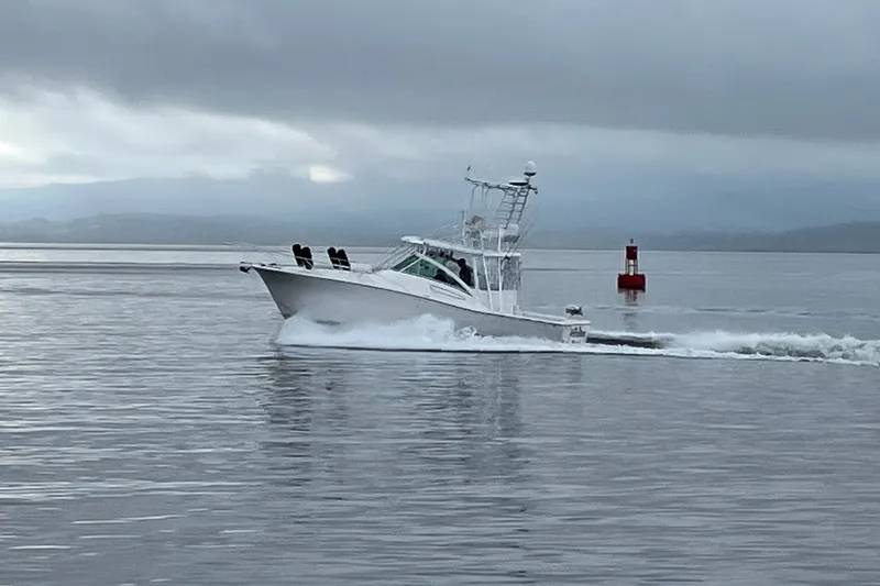 Slide: The Image of 2003 Luhrs 36 Open boat cruising on calm waters under cloudy skies. - 48