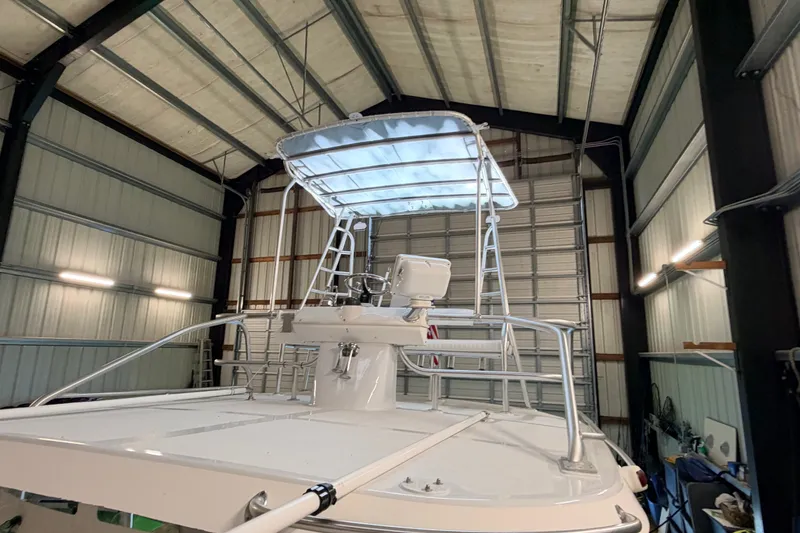 Slide: The Image of 2003 Luhrs 36 Open boat in a storage facility, showcasing its upper deck and structure. - 31