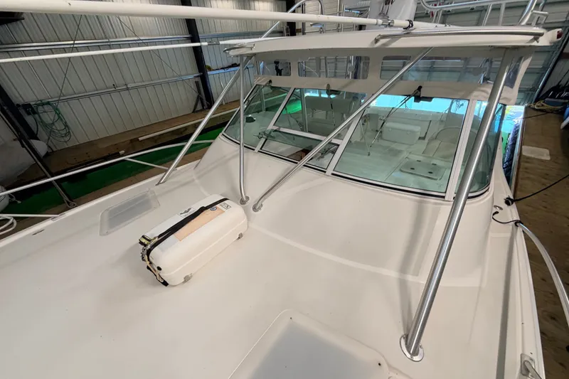 Slide: The Image of 2003 Luhrs 36 Open boat deck with safety equipment in a storage facility. - 28