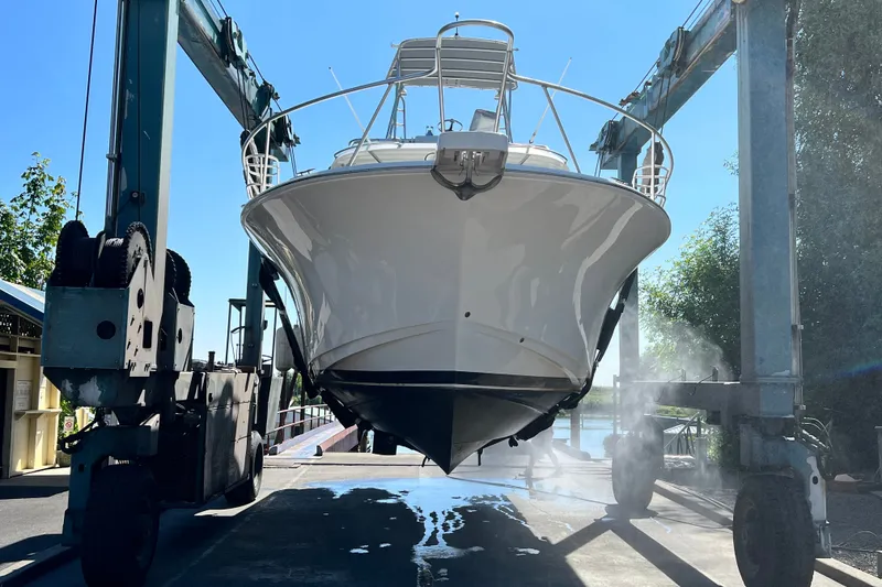 Slide: The Image of 2003 Luhrs 36 Open boat being lifted for maintenance on a sunny day. - 39