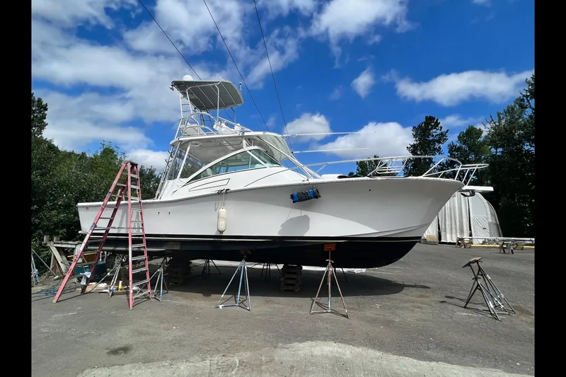 Slide: The Image of 2003 Luhrs 36 Open boat on stands, clear sky background. - 45