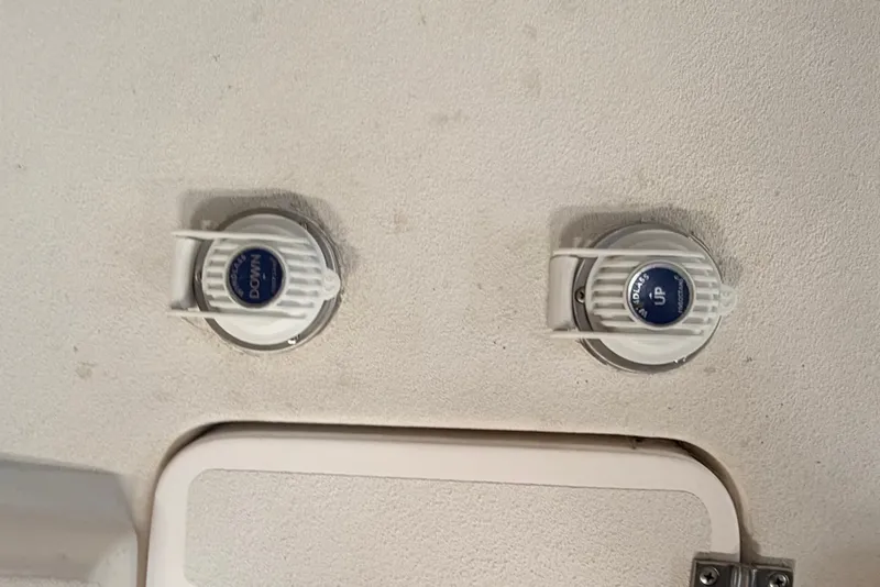 Slide: The Image of Boat controls on a 2003 Luhrs 36 Open, labeled "UP" and "DOWN." - 38