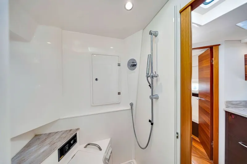 Slide: The Image of Bathroom interior of 2017 Pursuit SC 365i Sport Coupe with shower and wooden accents. - 34