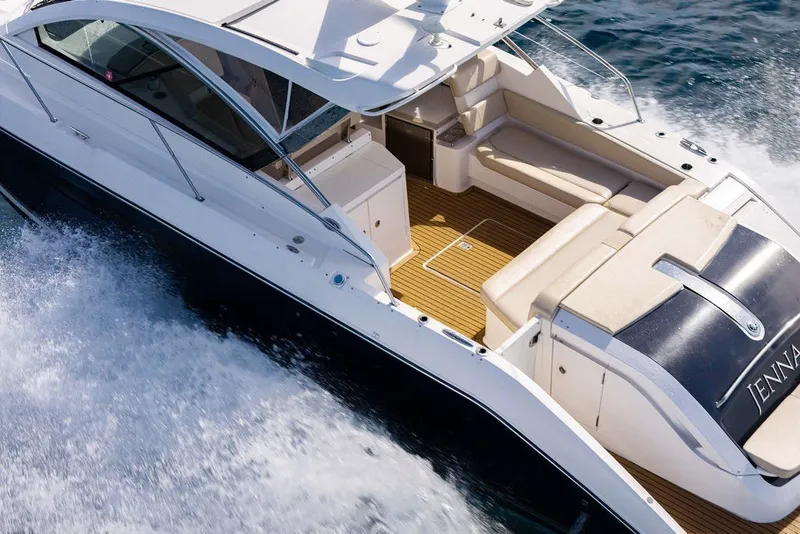 Slide: The Image of 2017 Pursuit SC 365i Sport Coupe cruising on water, showcasing sleek design and spacious deck. - 6