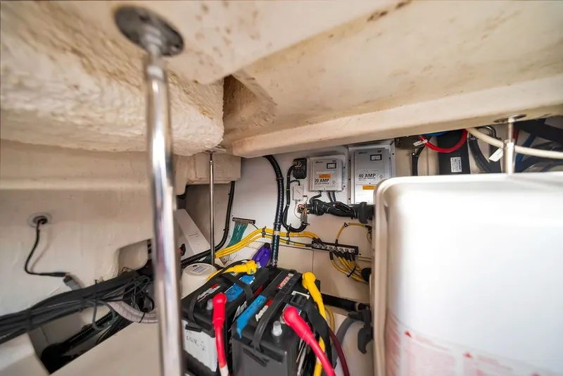 Slide: The Image of Electrical system inside 2017 Pursuit SC 365i Sport Coupe boat, featuring batteries and wiring. - 39