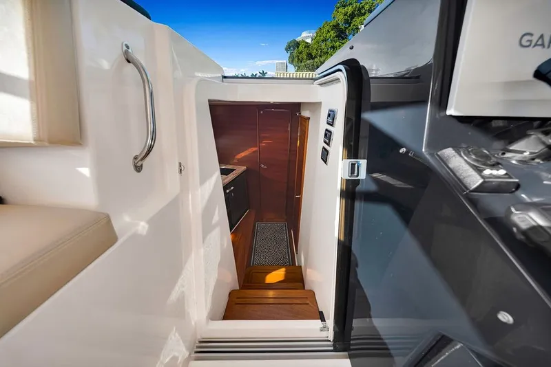 Slide: The Image of Interior view of 2017 Pursuit SC 365i Sport Coupe, showcasing cabin entrance and stairs. - 25