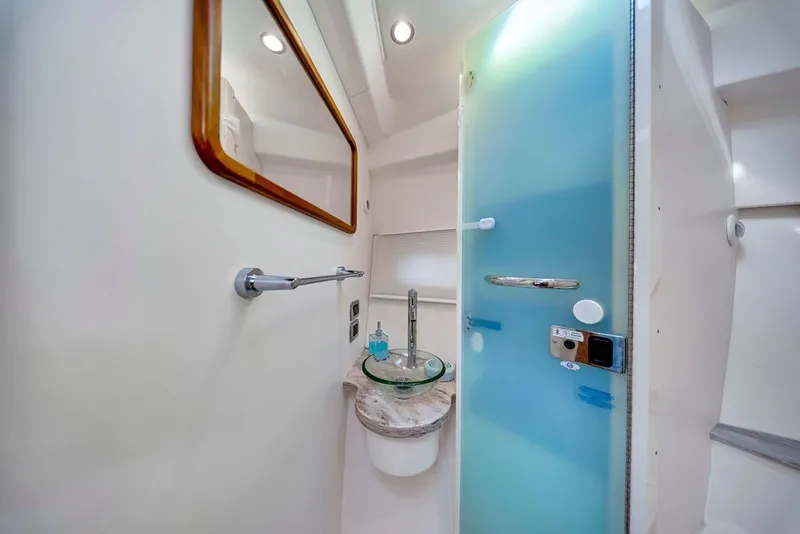 Slide: The Image of 2017 Pursuit SC 365i Sport Coupe bathroom with modern glass sink and frosted door. - 32