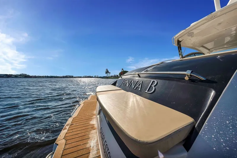 Slide: The Image of 2017 Pursuit SC 365i Sport Coupe on water, sunny day, rear view. - 12