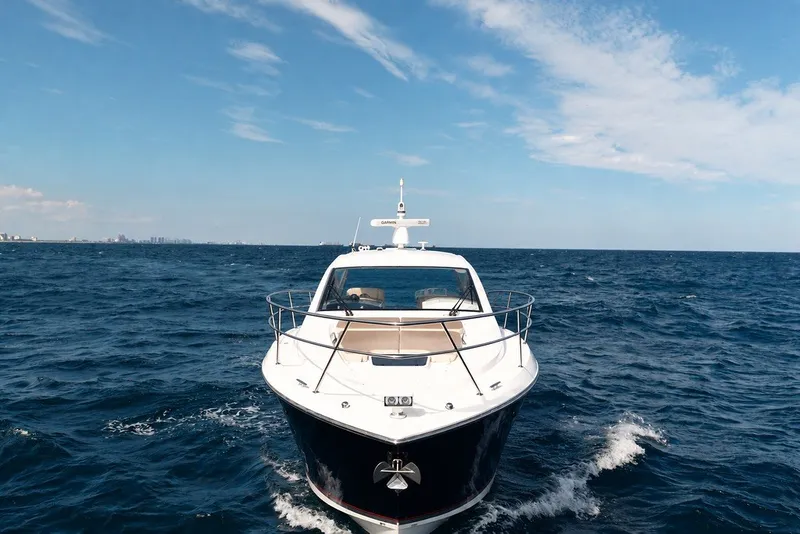 Slide: The Image of 2017 Pursuit SC 365i Sport Coupe cruising on open ocean under blue sky. - 9