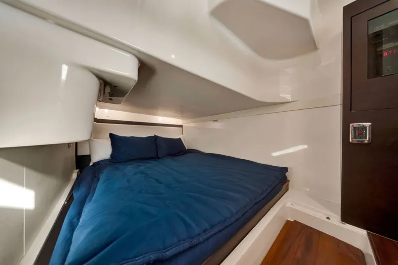 Slide: The Image of Cozy cabin interior of 2017 Pursuit SC 365i Sport Coupe with blue bedding. - 31