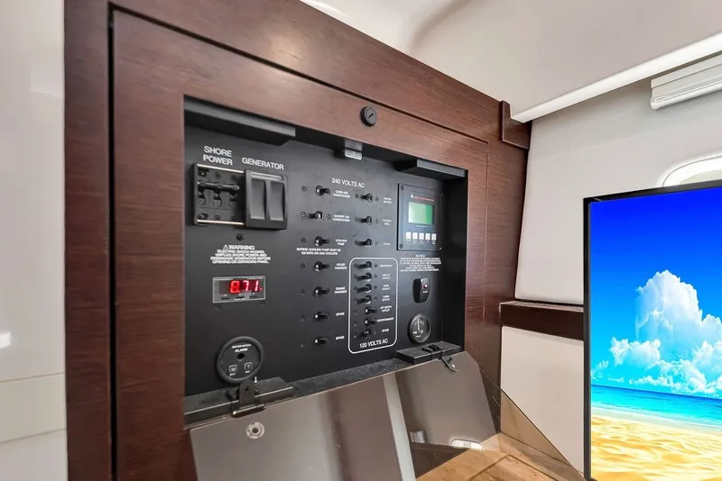 Slide: The Image of Control panel of 2017 Pursuit SC 365i Sport Coupe with shore power and generator switches. - 29