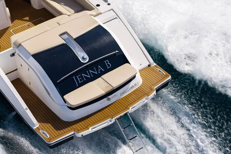 Slide: The Image of 2017 Pursuit SC 365i Sport Coupe cruising on water, rear view. - 5