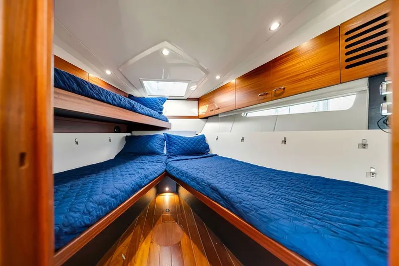 Slide: The Image of Luxurious cabin interior of 2017 Pursuit SC 365i Sport Coupe with blue bedding. - 35