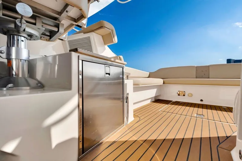 Slide: The Image of 2017 Pursuit SC 365i Sport Coupe deck with seating and storage under clear blue sky. - 20