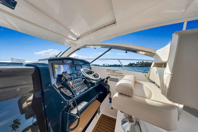 Slide: The Image of Helm of 2017 Pursuit SC 365i Sport Coupe with ocean view and modern controls. - 23