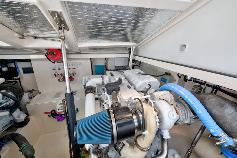 Slide: The Image of Engine room of a 2005 Cabo 35 Express boat, showcasing mechanical components and systems. - 29