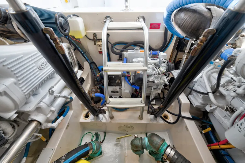 Slide: The Image of Engine room of a 2005 Cabo 35 Express boat, showcasing machinery and components. - 34