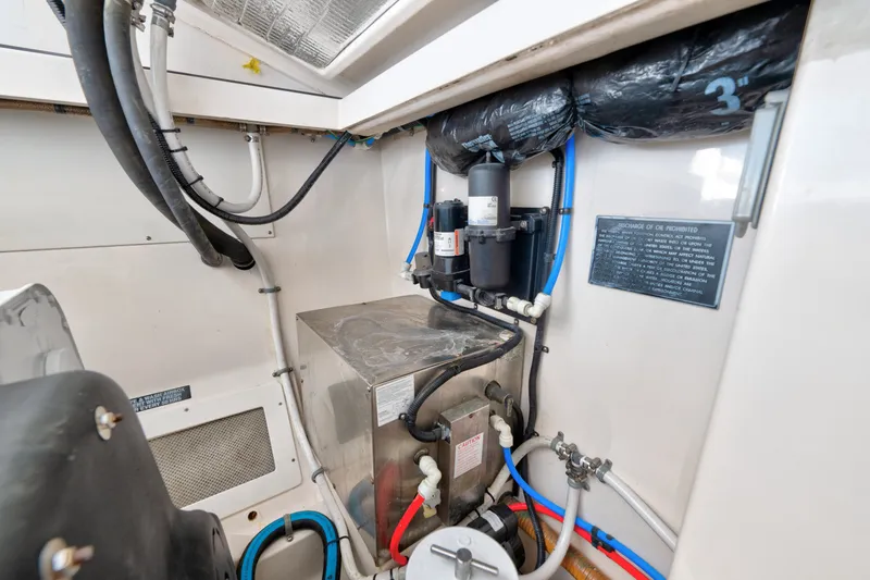 Slide: The Image of Engine room of 2005 Cabo 35 Express boat with visible piping and equipment. - 36
