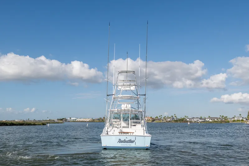 Slide: The Image of 2005 Cabo 35 Express boat on water under blue sky with clouds. - 1