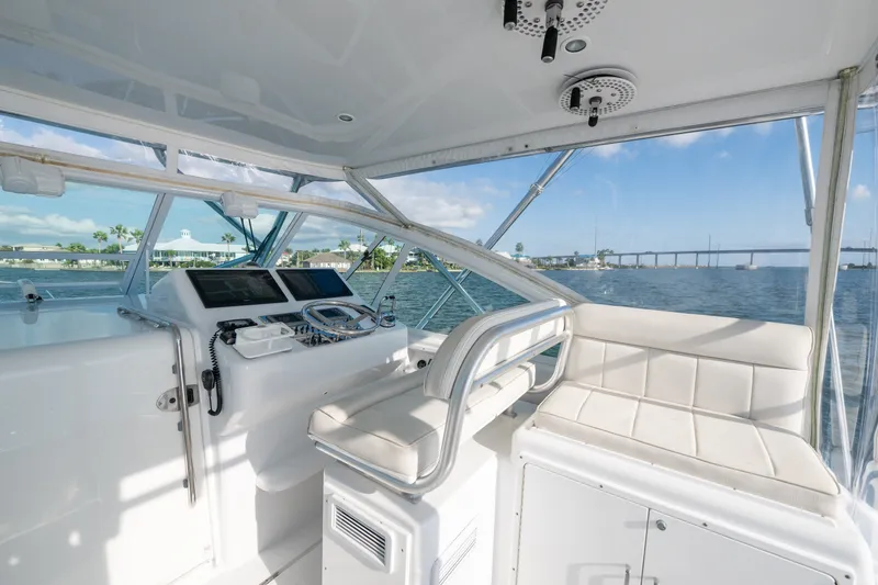 Slide: The Image of 2005 Cabo 35 Express yacht interior with helm, seating, and ocean view. - 4