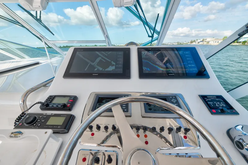 Slide: The Image of Helm of 2005 Cabo 35 Express boat with navigation screens and controls. - 5