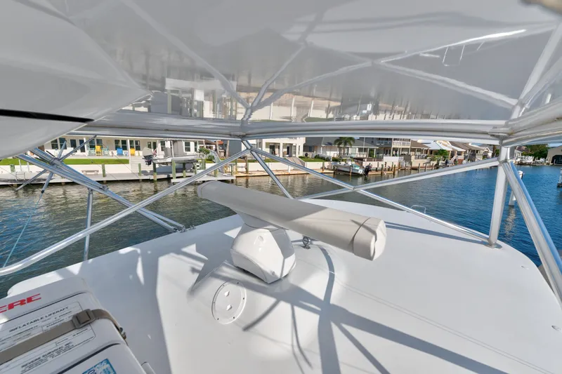 Slide: The Image of 2005 Cabo 35 Express boat with radar, docked near waterfront homes. - 20