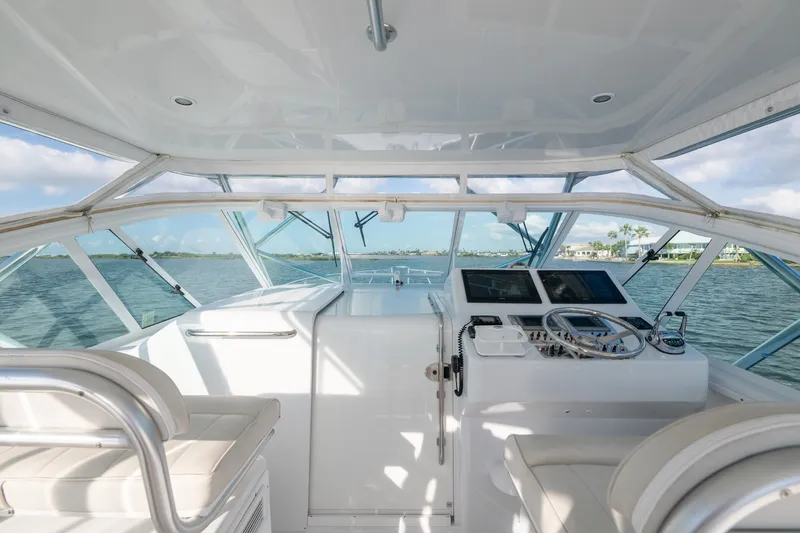 Slide: The Image of Interior view of 2005 Cabo 35 Express yacht cockpit with steering wheel and navigation equipment. - 3