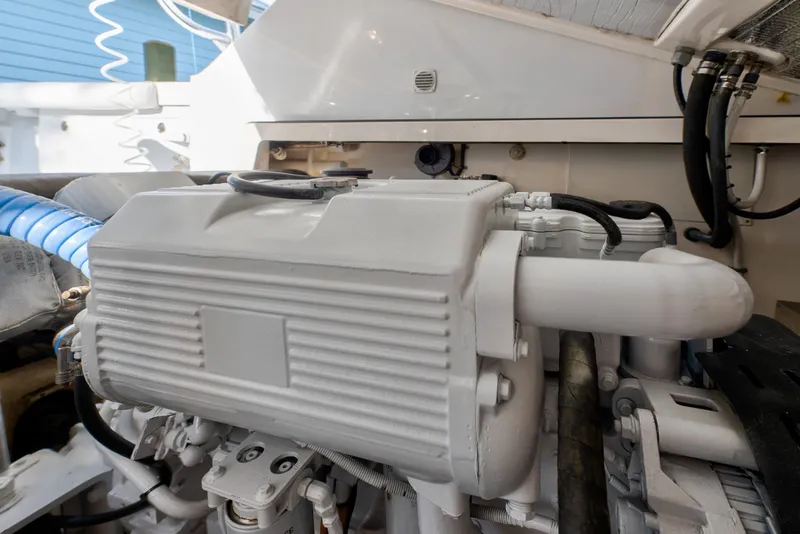 Slide: The Image of Engine compartment of a 2005 Cabo 35 Express boat, showcasing mechanical components. - 30
