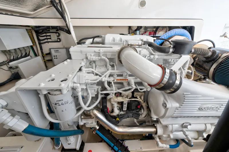 Slide: The Image of Engine compartment of a 2005 Cabo 35 Express boat, showcasing detailed mechanical components. - 32