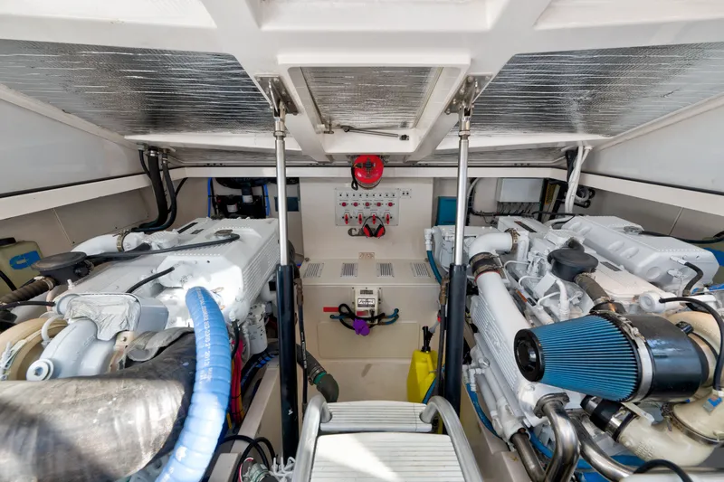 Slide: The Image of Engine room of a 2005 Cabo 35 Express boat, showcasing dual engines and mechanical components. - 27