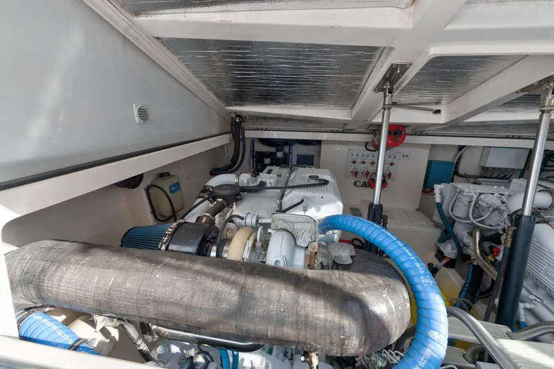 Slide: The Image of Engine room of a 2005 Cabo 35 Express boat, showcasing mechanical components and wiring. - 28