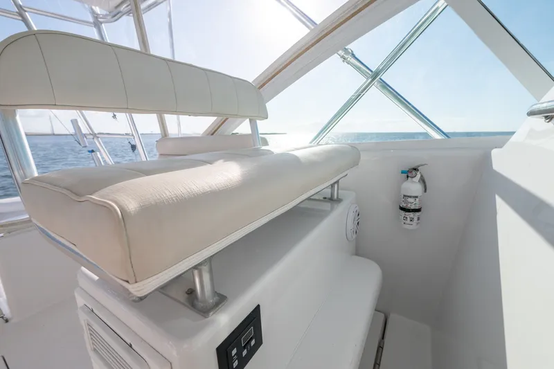 Slide: The Image of Interior of 2005 Cabo 35 Express boat with cushioned seating and ocean view. - 8