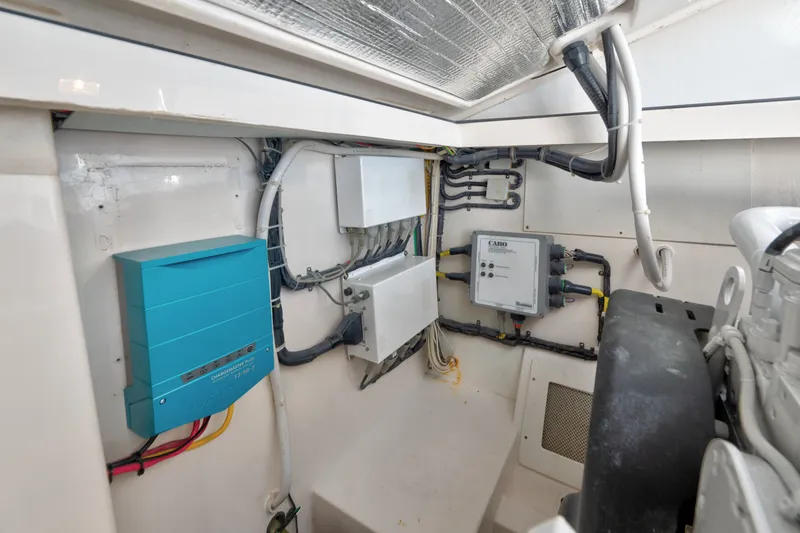 Slide: The Image of Engine room of 2005 Cabo 35 Express boat with electrical components and wiring. - 37