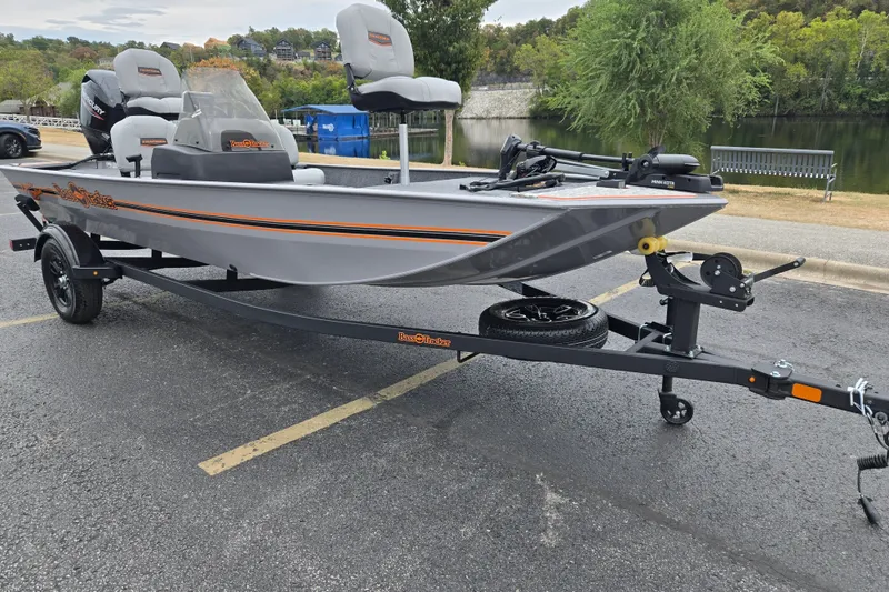 The Image of 2027 Tracker Bass Tracker Classic Limited boat on trailer by a lake. - 0