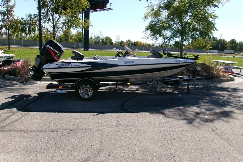 The Image of 2002 Triton Tr-175 SC boat with Mercury engine on trailer, parked outdoors. - 0