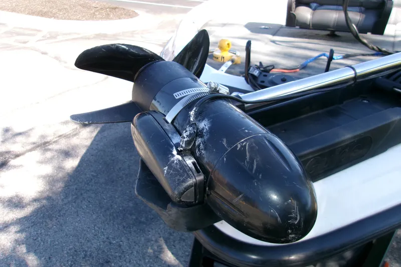 Slide: The Image of Close-up of a 2002 Triton Tr-175 SC boat motor with visible wear and scratches. - 8
