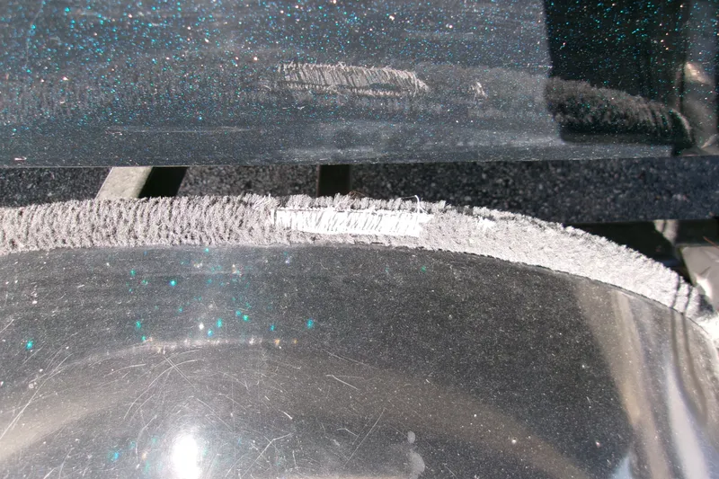 Slide: The Image of Close-up of a 2002 Triton Tr-175 SC boat surface with visible wear and texture. - 6