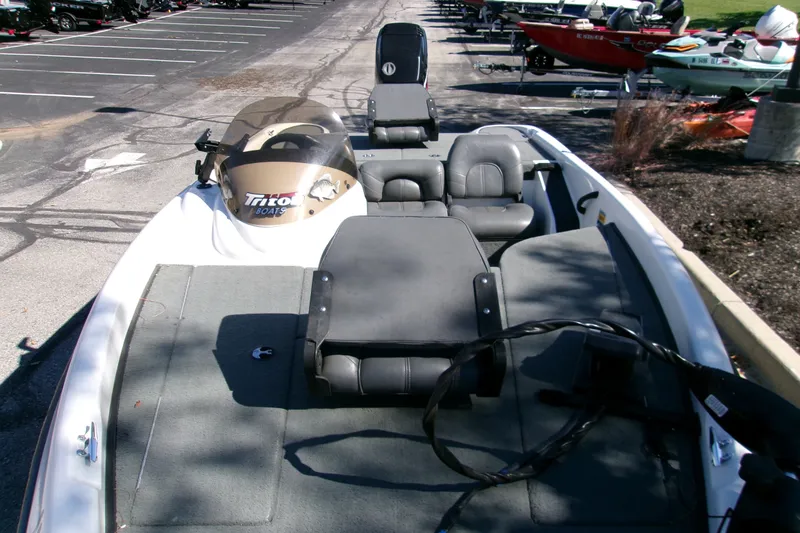 Slide: The Image of 2002 Triton Tr-175 SC boat with seating, parked in a lot, showcasing interior layout. - 4
