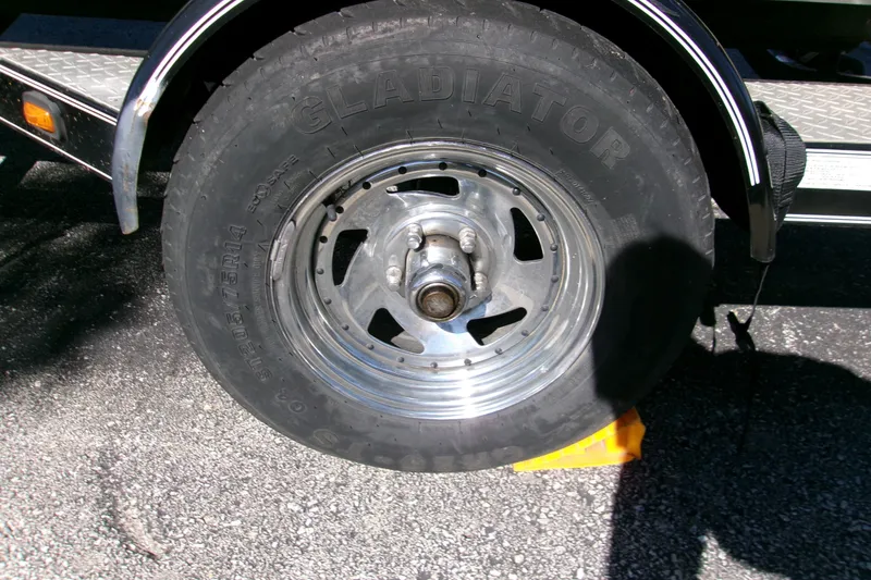 Slide: The Image of Triton Tr-175 SC 2002 trailer wheel with Gladiator tire on asphalt. - 9