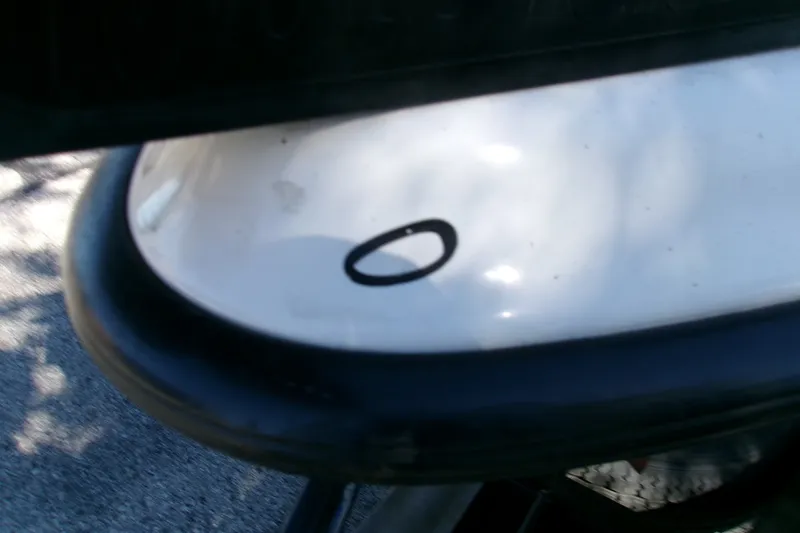 Slide: The Image of Close-up of a 2002 Triton Tr-175 SC boat detail with a black oval mark. - 7