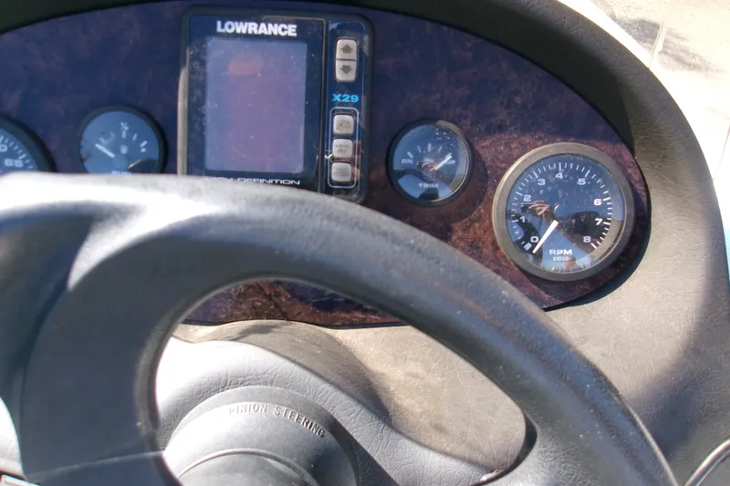 Slide: The Image of Dashboard of a 2002 Triton Tr-175 SC boat with steering wheel and gauges. - 5