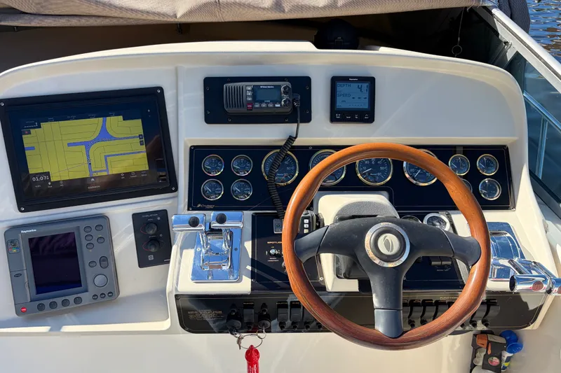 Slide: The Image of Helm of 2000 CUISERS Cruisers 3575 Express with navigation and control instruments. - 6