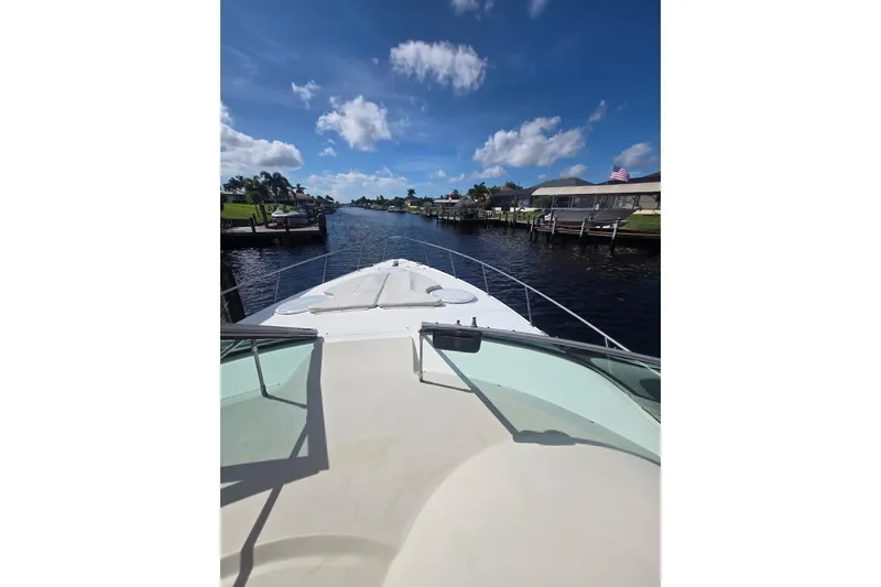 Slide: The Image of 2000 CUISERS Cruisers 3575 Express yacht cruising on a sunny canal. - 3