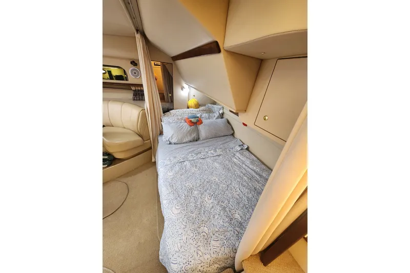 Slide: The Image of Cozy cabin interior of 2000 Cruisers 3575 Express yacht with bed and seating area. - 10