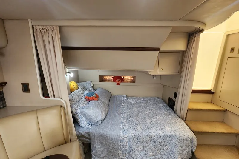 Slide: The Image of Interior cabin of 2000 CUISERS Cruisers 3575 Express with cozy bed and plush decor. - 13