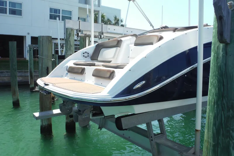 Slide: The Image of 2011 Yamaha Boats 242 Limited on lift, docked in marina. - 44