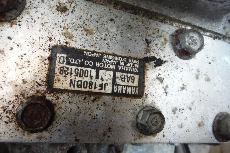 Slide: The Image of Close-up of a Yamaha 242 Limited 2011 engine plate with bolts and rust. - 26