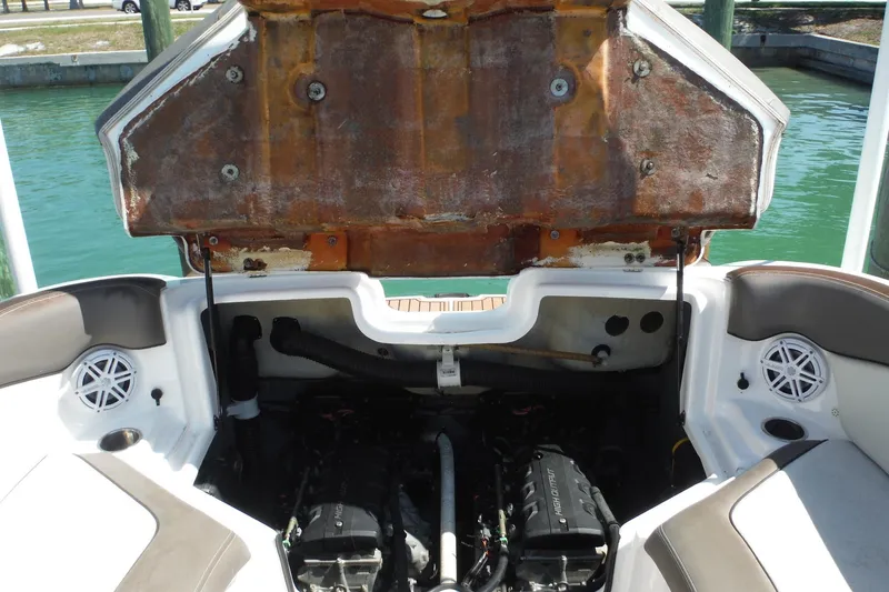 Slide: The Image of 2011 Yamaha Boats 242 Limited engine compartment with open hatch, dockside view. - 31